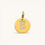 Nadare Co. gold initial E charm with pavé diamond accents on a polished disc.