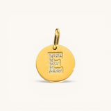 Nadare Co. gold initial E charm with pavé diamond accents on a polished disc.