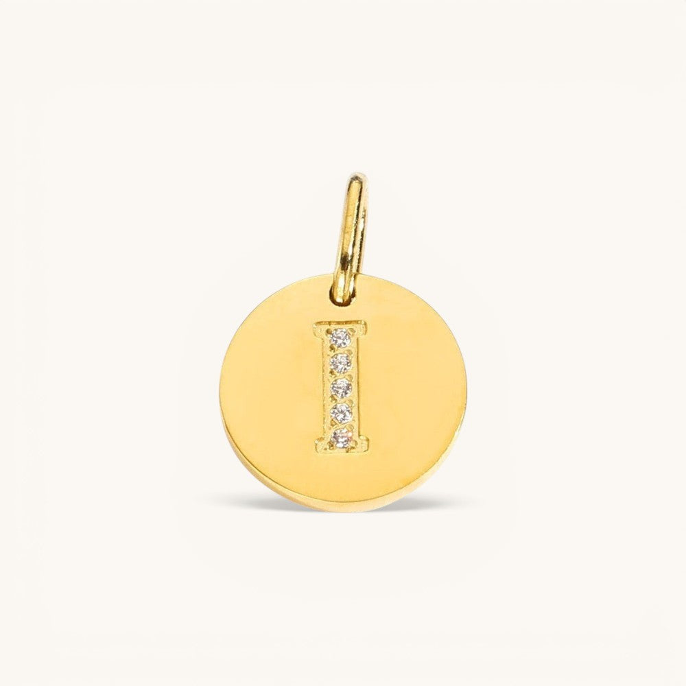Nadare Co. gold initial 'I' charm with pavé diamond detailing on a polished disc.
