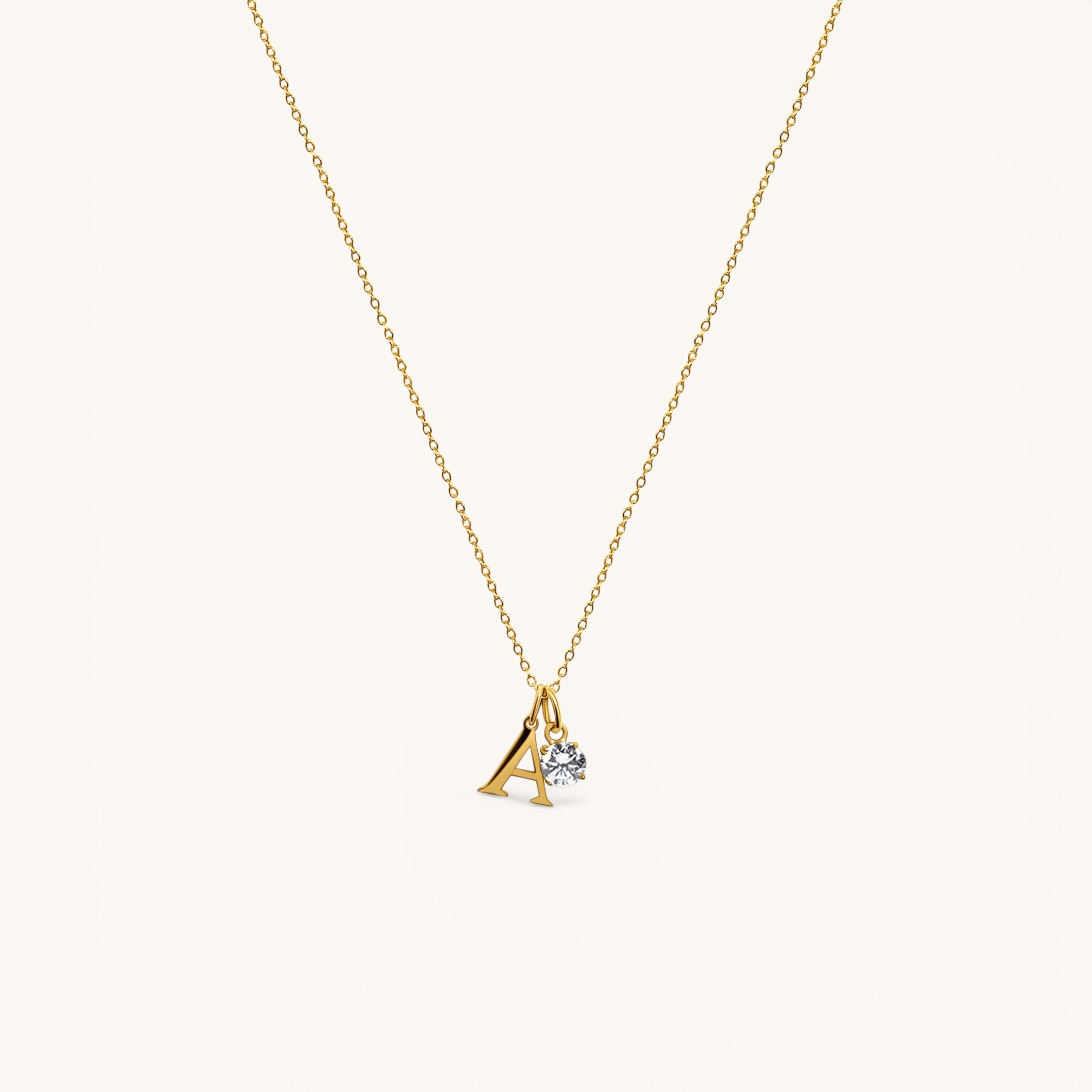 Nadare Co. gold plated stainless steel necklace featuring an uppercase serif letter A charm and a small crystal.