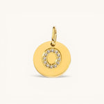 Nadare Co. gold initial "O" charm with pavé diamonds on a polished disc.