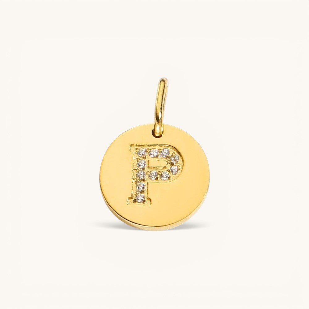Nadare Co. gold initial P charm with pavé diamond detailing on a polished disc.