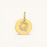 Nadare Co. gold initial Q charm with pavé crystal accents on a polished disc.