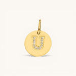 Nadare Co. gold initial U charm with pavé crystal detailing on a polished disc.