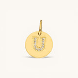 Nadare Co. gold initial U charm with pavé crystal detailing on a polished disc.
