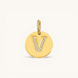 Nadare Co. gold initial V charm with pavé set cubic zirconia on a polished disc.