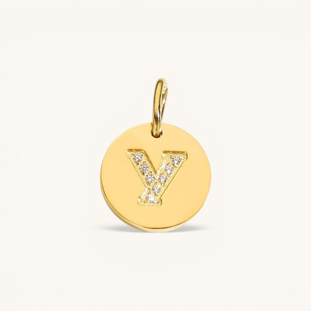 Nadare Co. gold initial Y charm with pavé set diamonds on a polished disc.