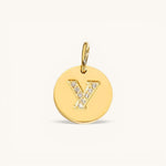 Nadare Co. gold initial Y charm with pavé set diamonds on a polished disc.