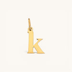 Nadare Co. lowercase letter k charm in 14k gold-plated stainless steel with a polished finish.