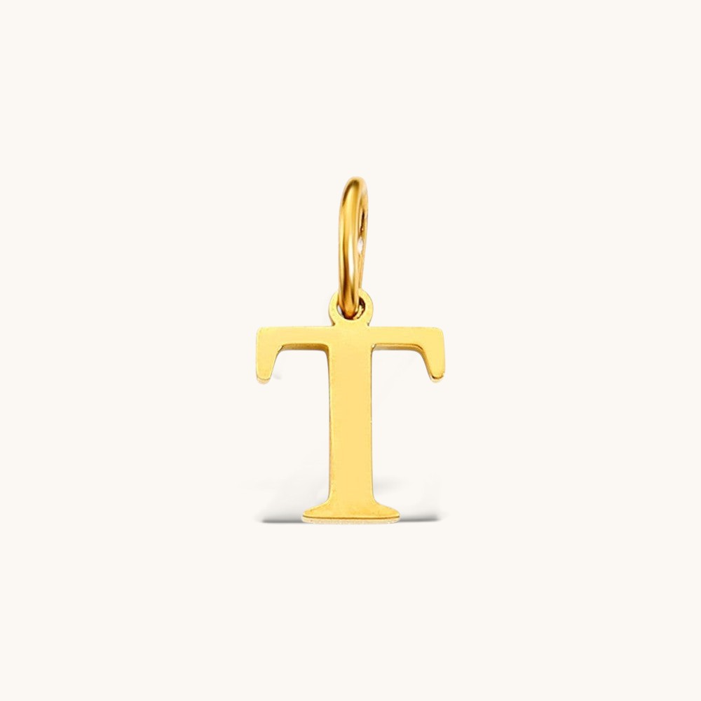 Nadare Co. gold-plated stainless steel initial charm featuring a polished serif letter T for everyday layering.