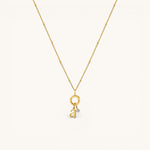 Nadare Co. gold-plated stainless steel lowercase letter a charm necklace with a delicate beaded chain and diamond accent