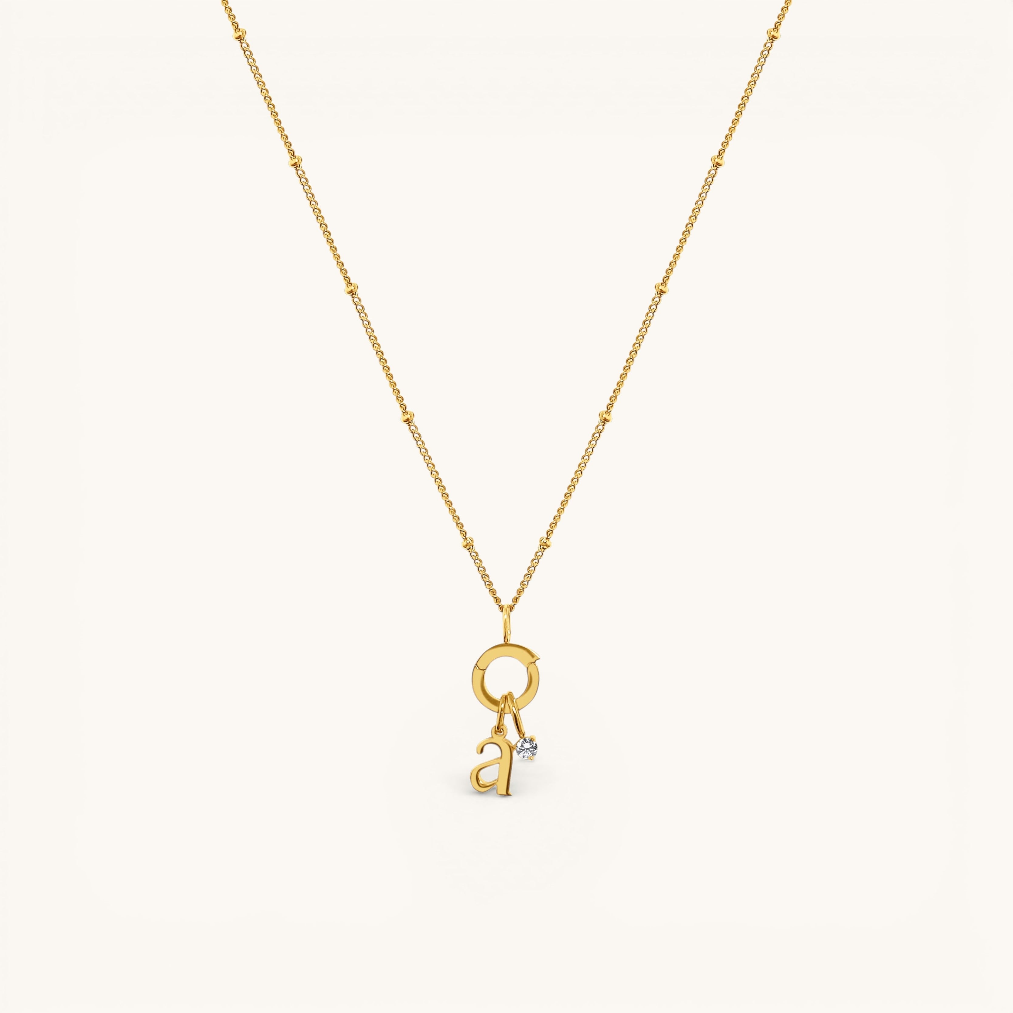 Nadare Co. gold-plated stainless steel lowercase letter a charm necklace with a delicate beaded chain and diamond accent