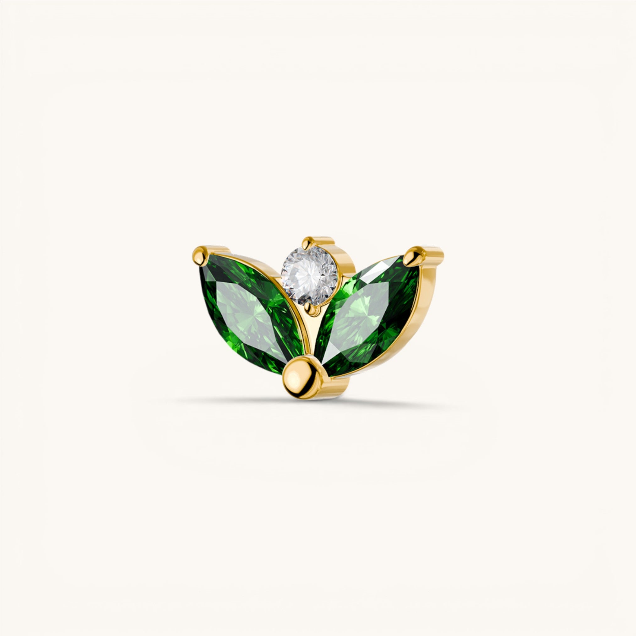 Nadare Co. gold threadless piercing front with two green marquise-cut CZ stones and one round white CZ accent.