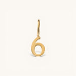 Nadare Co. number six charm in 14k gold-plated stainless steel with a minimalist polished finish.