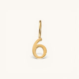 Nadare Co. number six charm in 14k gold-plated stainless steel with a minimalist polished finish.