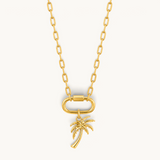 Nadare Co. large gold-plated stainless steel palm tree charm pendant on a matching gold chain with a carabiner clasp.