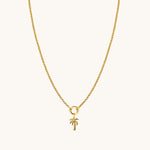 Nadare Co. gold palm tree charm on a delicate gold chain necklace for a coastal vacation look.