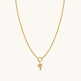 Nadare Co. gold palm tree charm on a delicate gold chain necklace for a coastal vacation look.