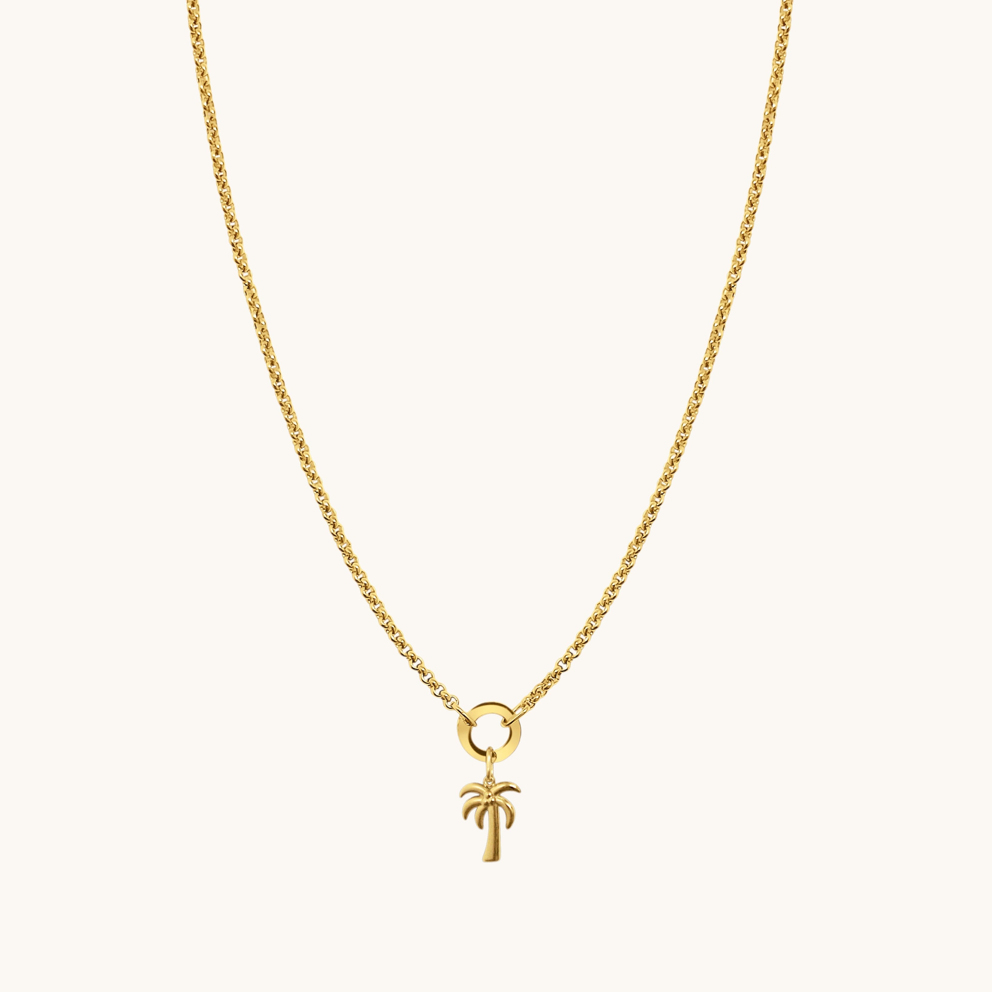 Nadare Co. gold palm tree charm on a delicate gold chain necklace for a coastal vacation look.