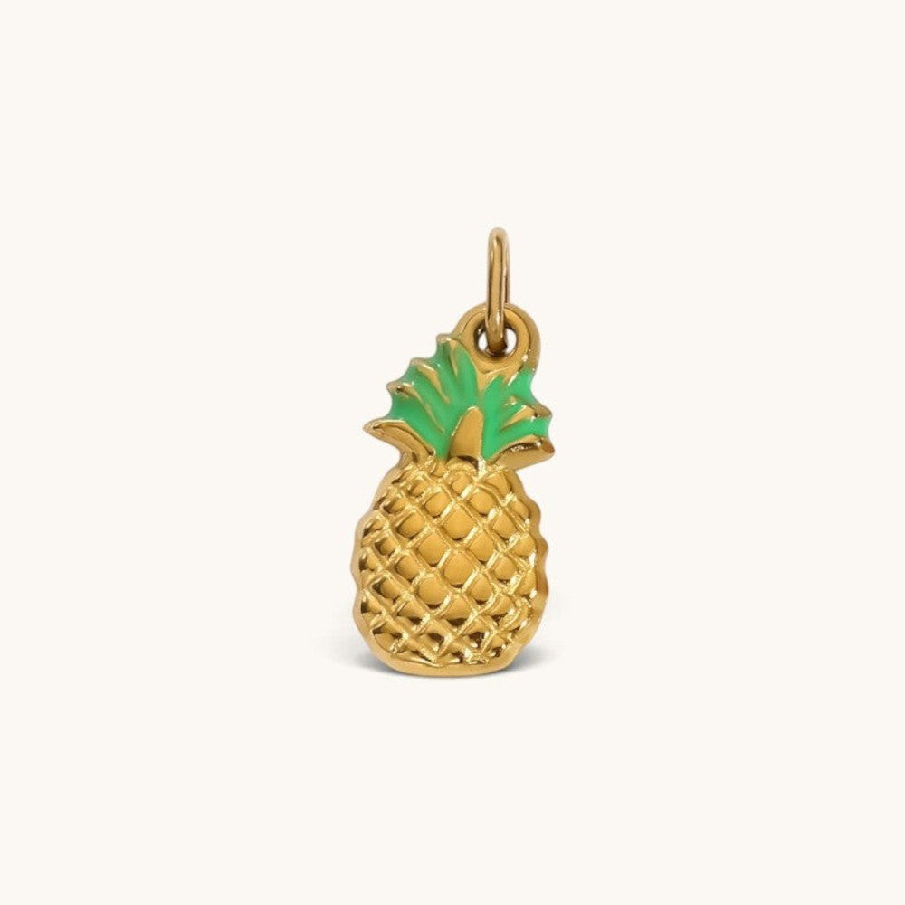 Nadare Co. Pineapple Charm in textured gold with bright green enamel leaves for a tropical necklace accessory.