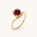 Nadare Co. Lumen birthstone ring featuring a round red garnet stone set in a polished gold band.