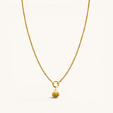 Nadare Co. gold-plated stainless steel scallop shell charm pendant on a delicate gold chain necklace.