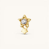 Nadare Co. gold titanium shooting star threadless piercing front with a central cubic zirconia and dangling charm.