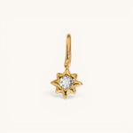 Nadare Co. gold star charm pendant featuring a central sparkling white diamond on a polished yellow gold setting.