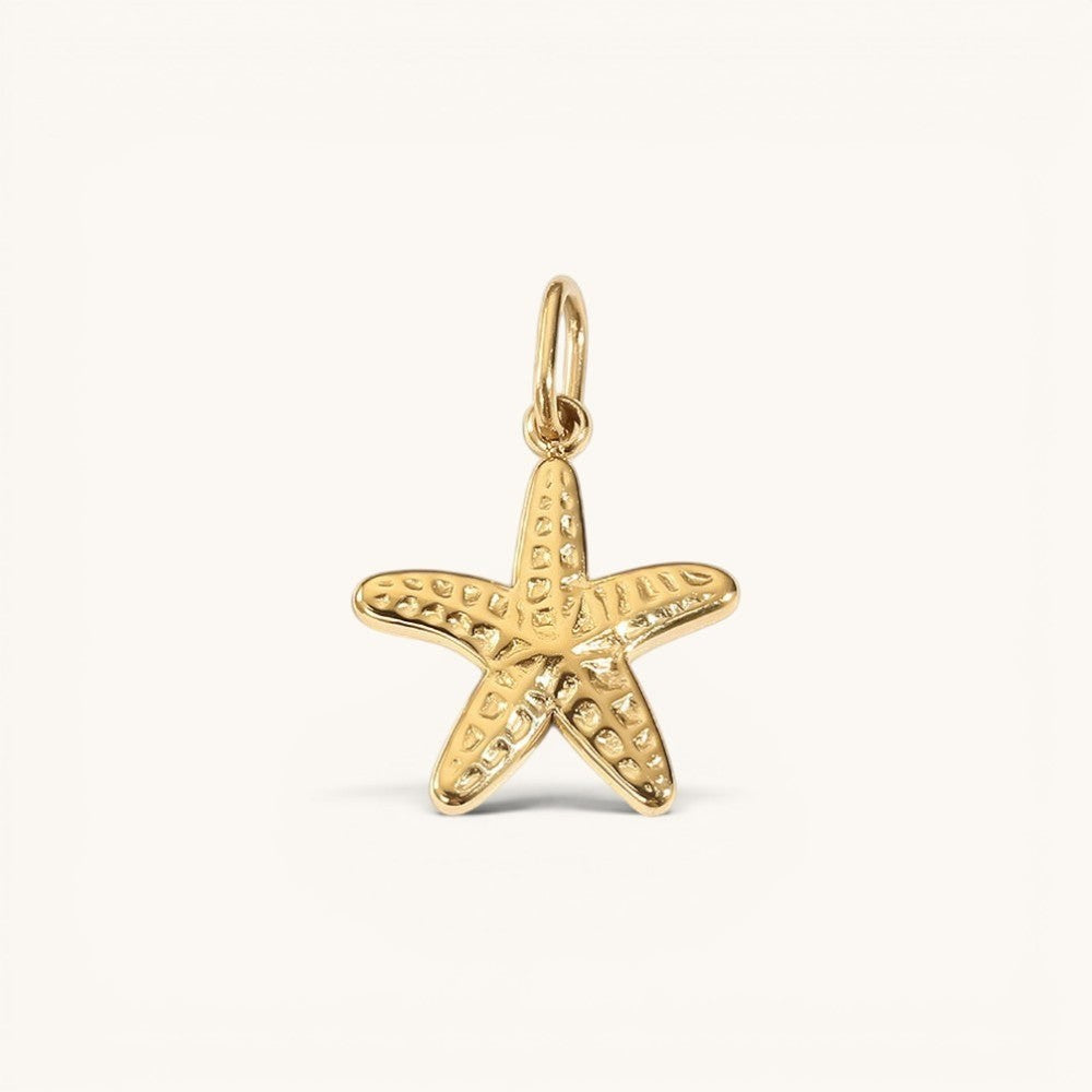 Nadare Co. mini starfish charm in 14k gold plated stainless steel with a textured, rounded coastal design.