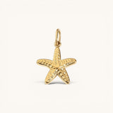 Nadare Co. mini starfish charm in 14k gold plated stainless steel with a textured, rounded coastal design.