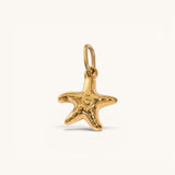 Nadare Co. mini starfish charm in 14k gold-plated stainless steel with a polished, rounded coastal design.