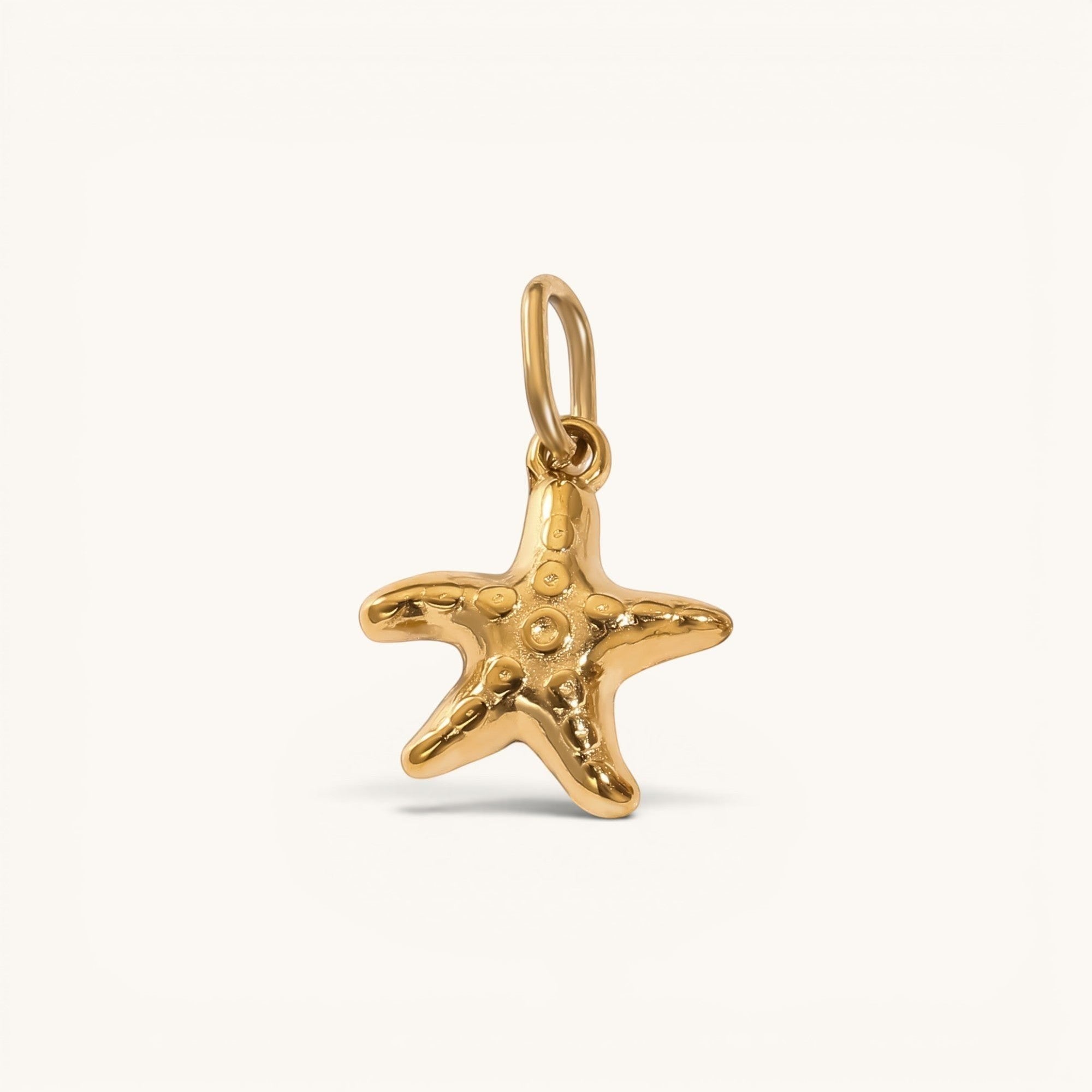 Nadare Co. mini starfish charm in 14k gold-plated stainless steel with a polished, rounded coastal design.