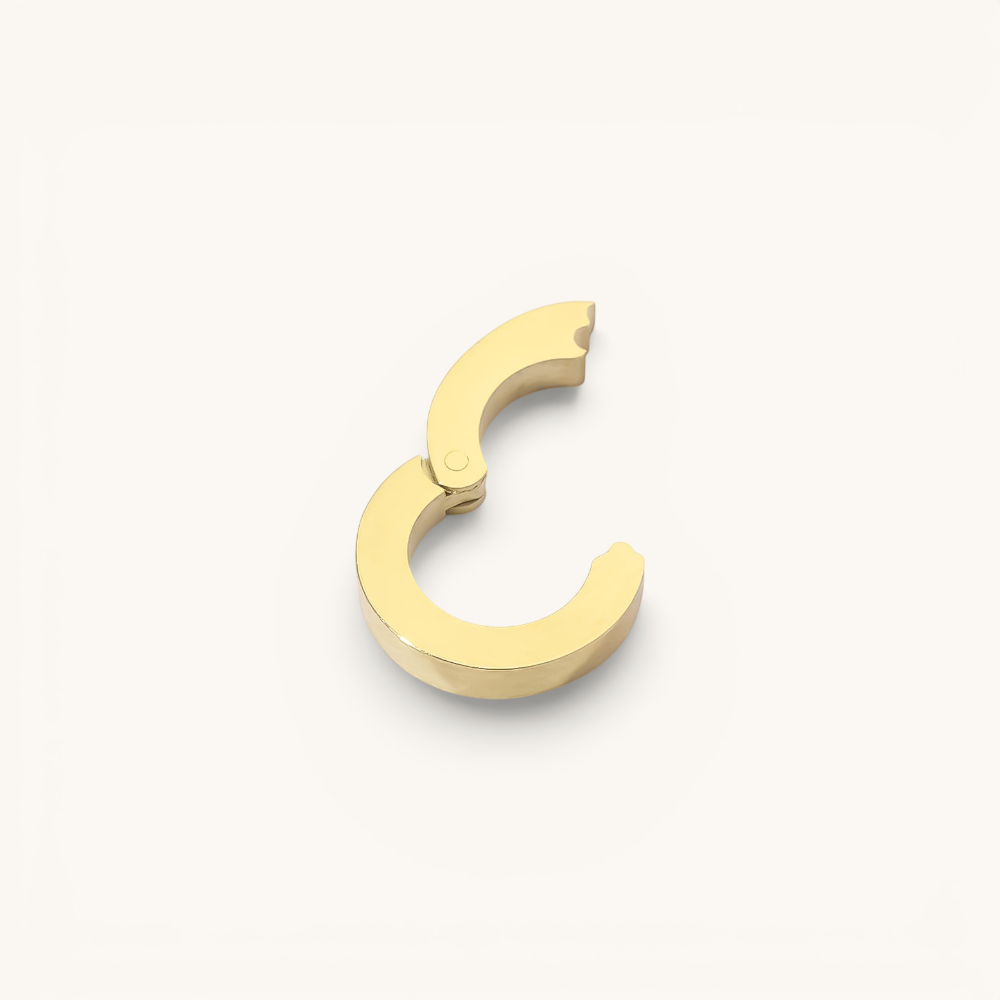 Nadare Co. gold circular switch clasp for charm necklaces, designed to hold up to three charms.