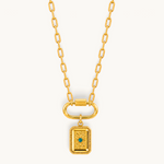 Nadare Co. gold rectangle tablet charm necklace with a central green cubic zirconia stone on a link chain