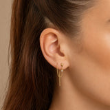 Nadare Co. gold threader earring with chain and crystal detail worn in a model ear piercing