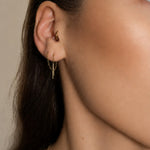 Nadare Co. gold chain threader earrings worn in a pierced earlobe with a small hoop in the tragus