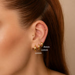 Nadare Co. gold titanium Cleo Clicker Hoops in 8mm, 10mm, and 12mm sizes worn in a model's ear piercings.