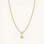 Nadare Co. gold-plated zodiac charm necklace with cubic zirconia accents on a delicate chain against a white background