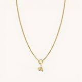 Nadare Co. gold-plated zodiac charm necklace with cubic zirconia accents on a delicate chain against a white background