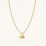 Nadare Co. gold plated stainless steel zodiac charm necklace with cubic zirconia accents on a delicate chain