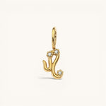 Nadare Co. gold plated Zodiac Charm featuring cubic zirconia accents on a stainless steel base