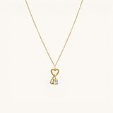 Nadare Co. 14k gold plated necklace featuring a gothic initial charm and a sparkling rectangular birthstone pendant.