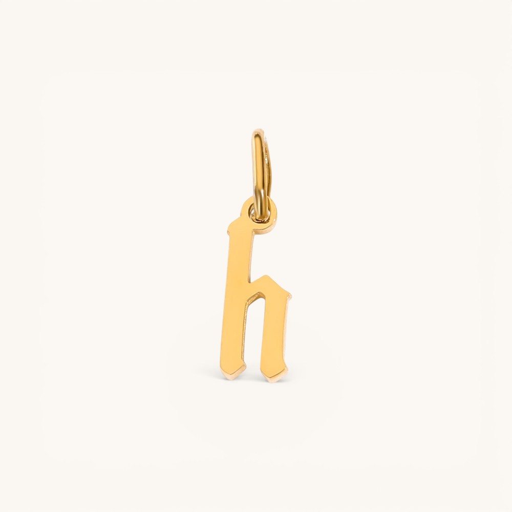 Nadare Co. gothic letter h charm in 14k gold plated stainless steel with sharp old-English typography