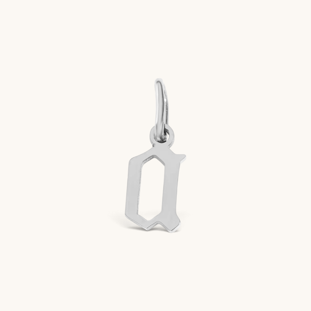Nadare Co. silver-toned stainless steel gothic letter Q charm with sharp edges for a necklace stack.