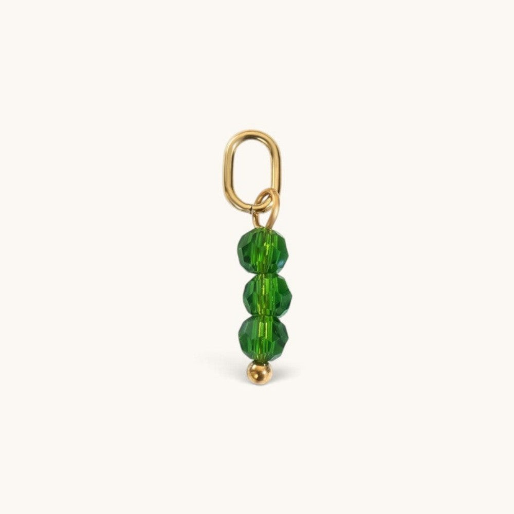 Nadare Co. birth month bead charm featuring three faceted green beads on a gold jump ring for necklace stacking.