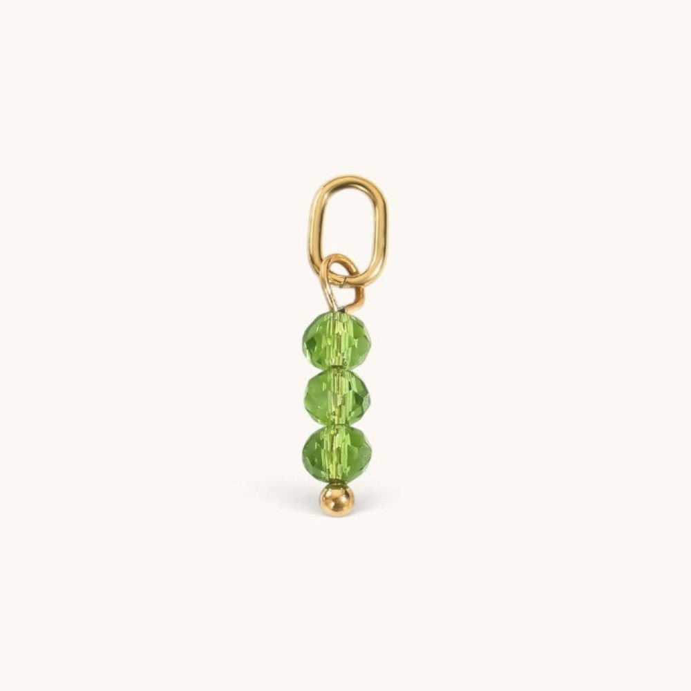 Nadare Co. birth month bead charm featuring three faceted green crystals on a gold jump ring for necklace stacking.