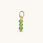 Nadare Co. birth month bead charm featuring three faceted green crystals on a gold jump ring for necklace stacking.