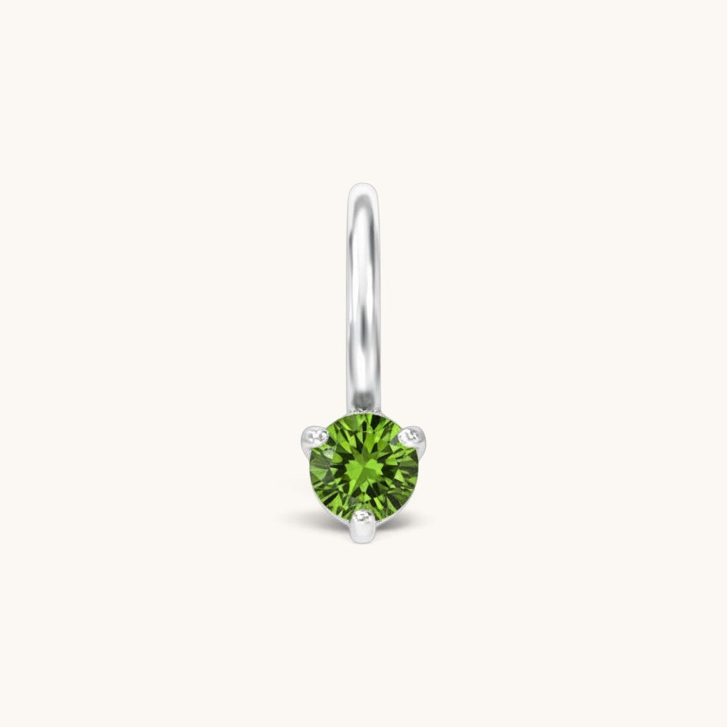 Nadare Co. mini birthstone charm featuring a round green cubic zirconia stone set in polished silver-tone metal.