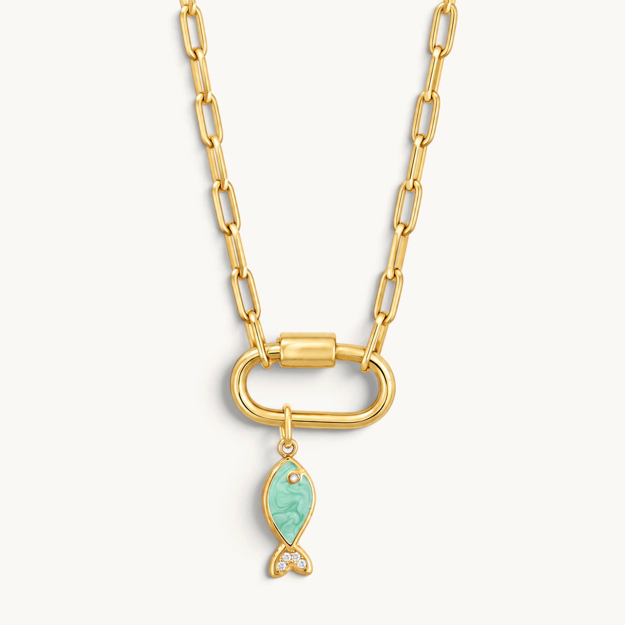 Nadare Co. gold chain necklace with a green enamel fish charm featuring cubic zirconia accents on a carabiner clasp.