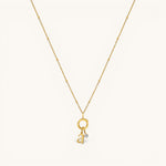 Nadare Co. 14k gold plated initial and mini birthstone necklace on a delicate beaded chain.